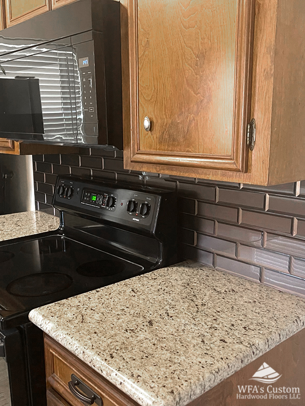 Dark Grey Subway tile backsplash in kitchen, wfa's custom hardwood floors, houston texas